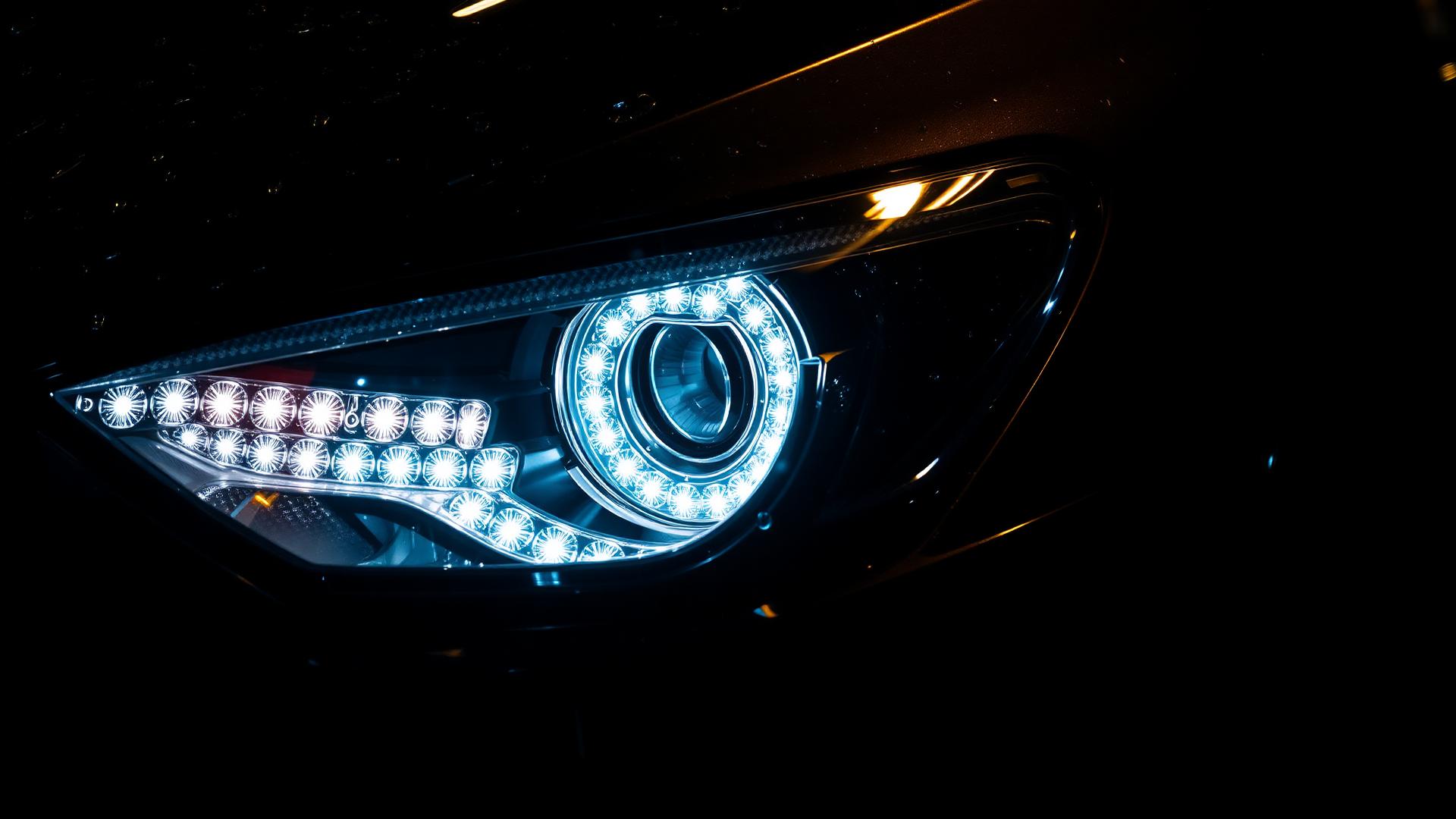 Modern LED car headlight glowing at night